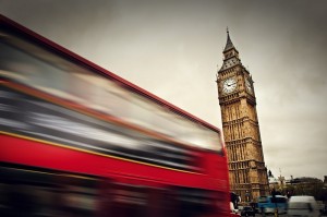 London, the UK. Red bus in motion and Big Ben