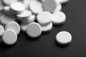 white pills over black background