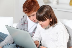 Children playing with laptop computer