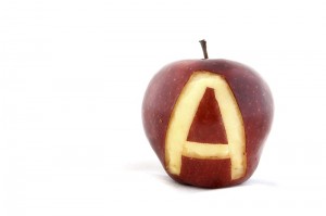 An apple with the letter A carved out of the skin