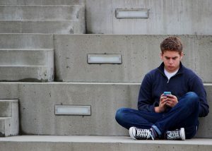 lonely teenager texting mobile phone_oncology news australia