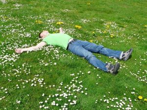 man sleeping napping night shift rest outdoors park grass_oncology news australia
