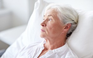 older woman bed hospital bed thoughtful reflective portrait_oncology news australia