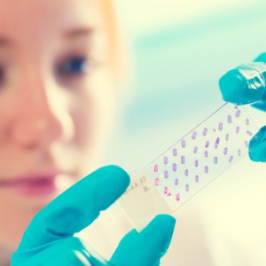 Girl with a slide for the microscope University Hospital