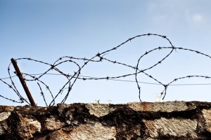 Stone wall with barbed wire
